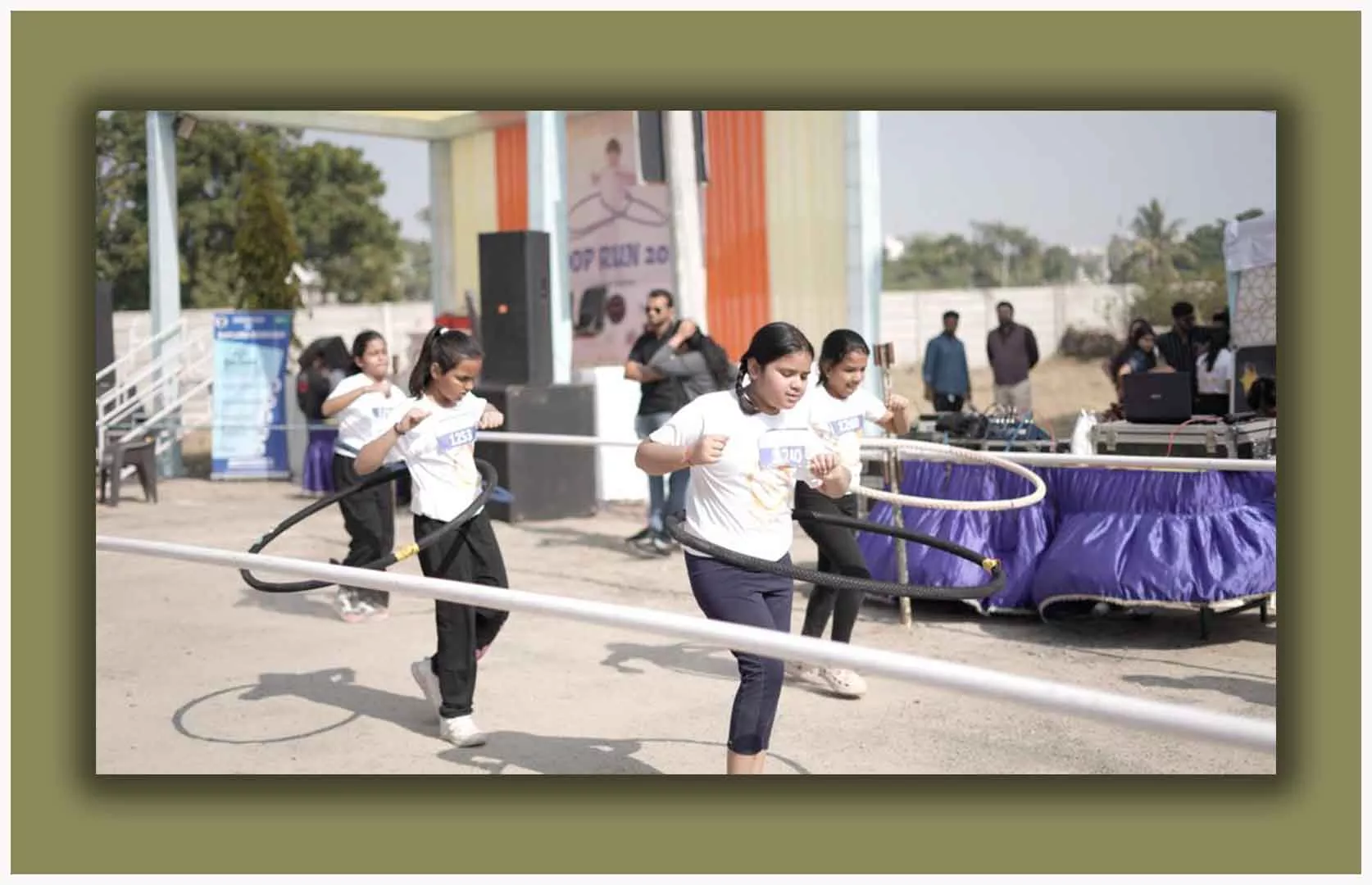 MAXIMUM DISTANCE COVERED BY MAXIMUM STUDENTS WHILE ROTATING HULA HOOP AROUND WAIST IN A RELAY FORMAT